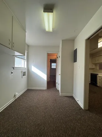 an empty room with windows and closet