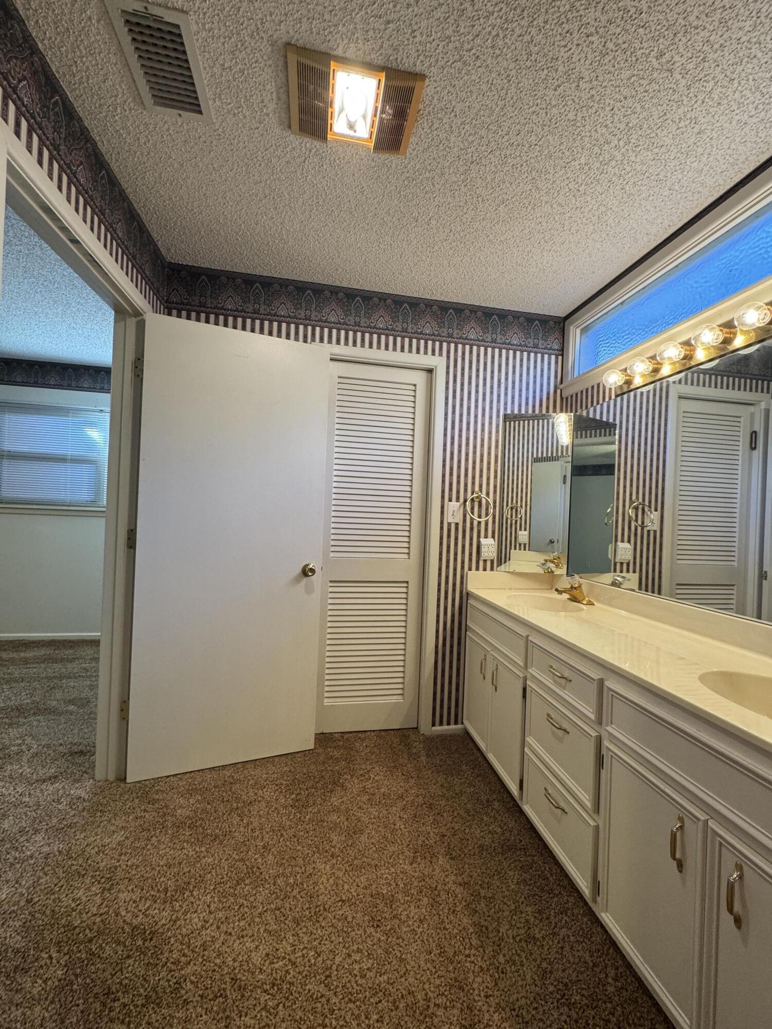 2208 South 4th Street Lamesa, TX 79331 - Photo 19 of 36 a bathroom with a granite countertop sink and a mirror