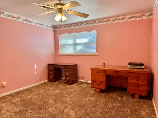 a view of a workspace with furniture