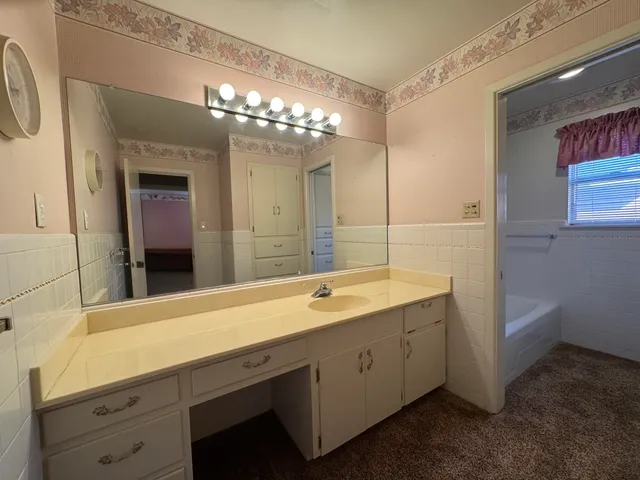 a bathroom with a double vanity sink and a mirror