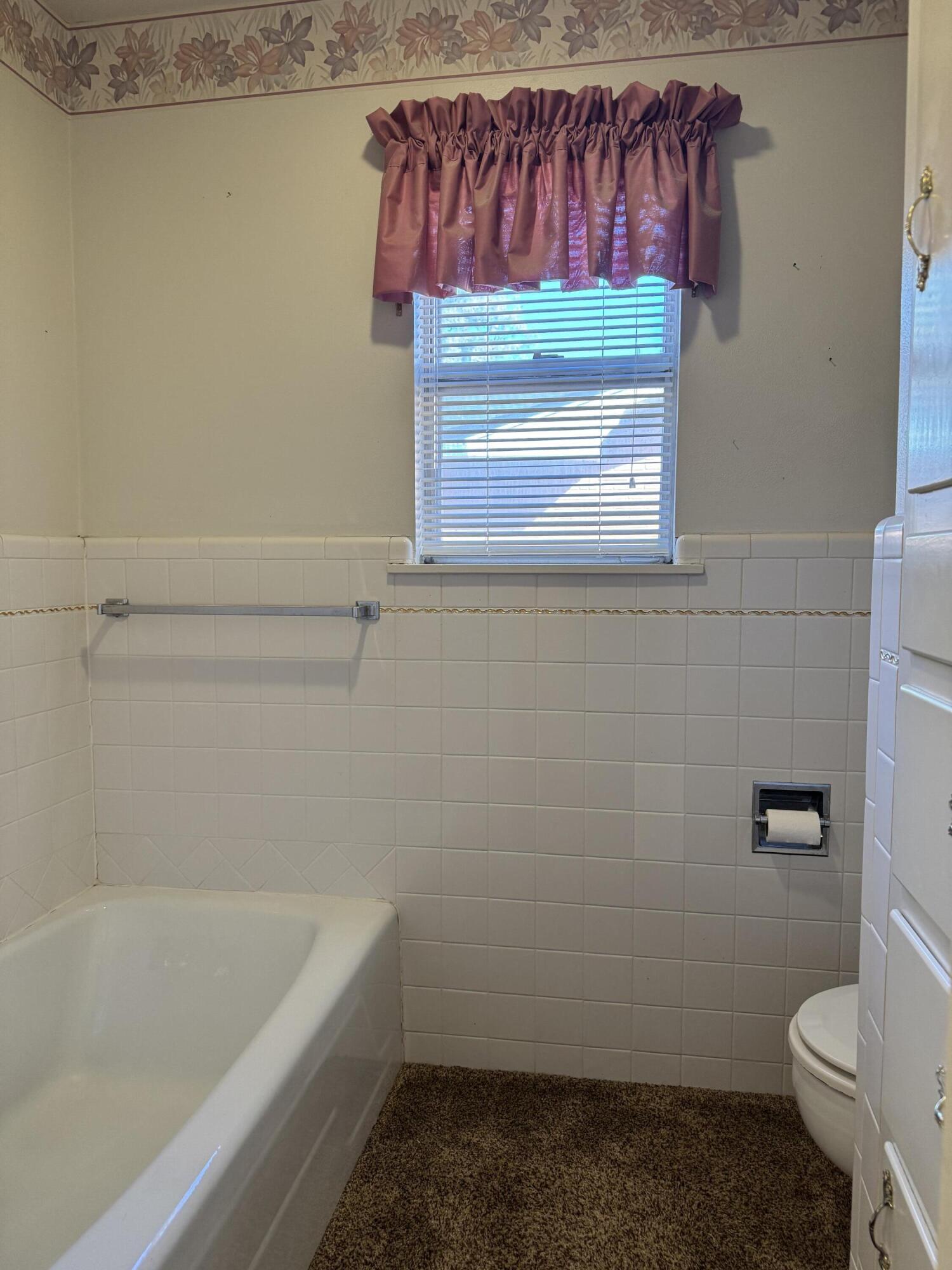 2208 South 4th Street Lamesa, TX 79331 - Photo 23 of 36 a bathroom with a sink and a toilet