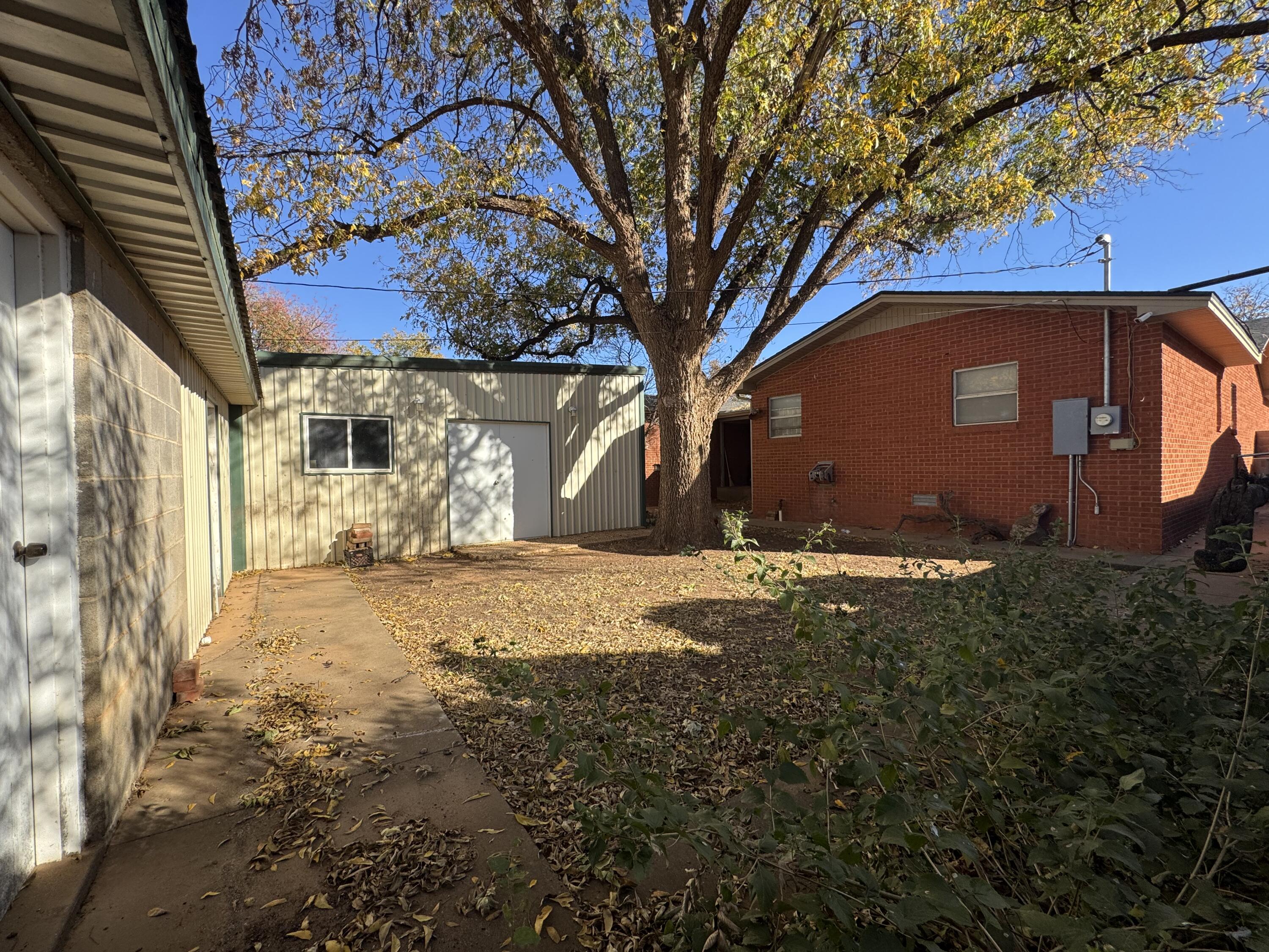 2208 South 4th Street Lamesa, TX 79331 - Photo 27 of 36 a view of a yard with a tree