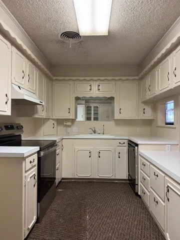 a kitchen with cabinets stainless steel appliances a sink and a counter top space