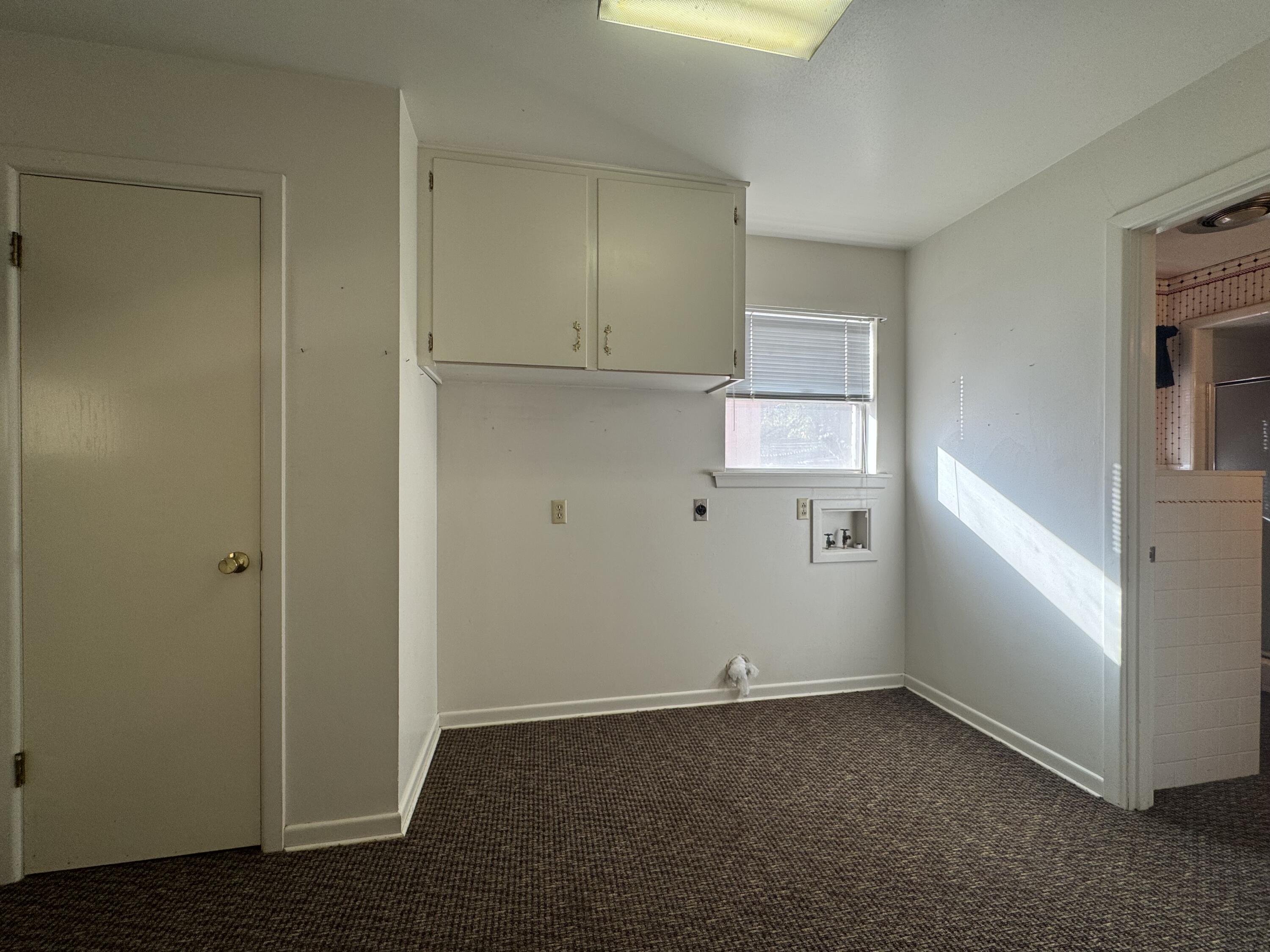 2208 South 4th Street Lamesa, TX 79331 - Photo 10 of 36 an empty room with wooden floor and windows