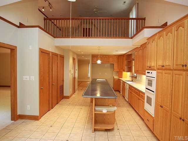 10005 Grafton Road Raleigh, NC 27615 - Photo 4 of 25 A kitchen every cook dreams about! Huge island/breakfast bar! Trash compactor, space enough for two refrigerators, wall oven and abundunce of pantry space and cabinets!