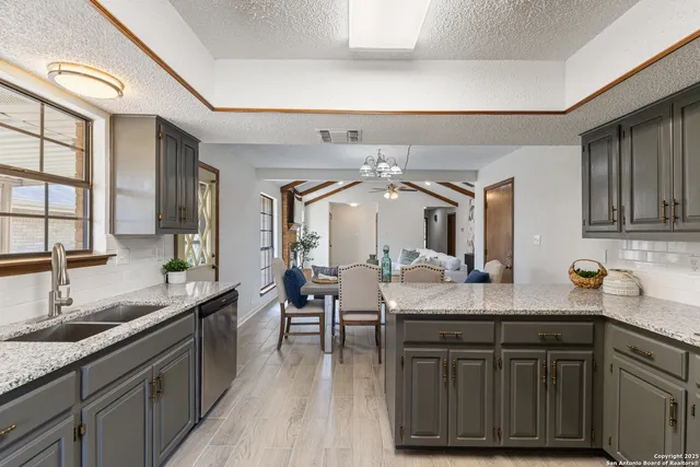 a kitchen with sink and cabinets