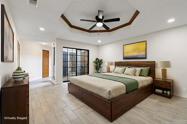 a spacious bedroom with a bed and a chandelier
