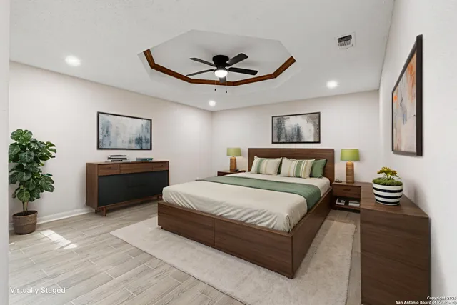 a spacious bedroom with a bed and a chandelier