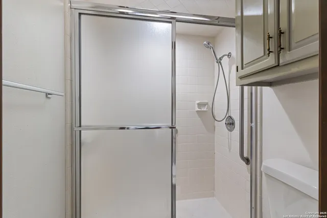 a bathroom with a glass shower door