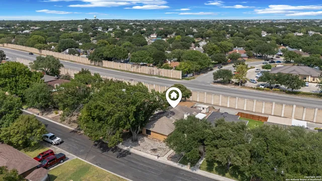 an aerial view of a house with a yard