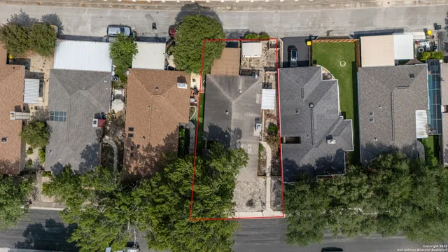 an aerial view of residential houses with outdoor space