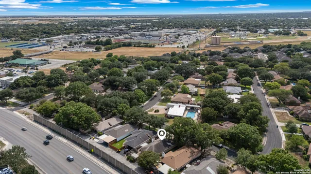 an aerial view of residential building and car parked on road