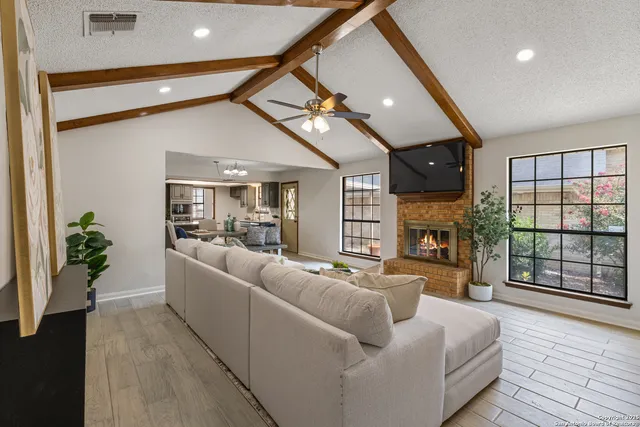 a living room with furniture and a fireplace