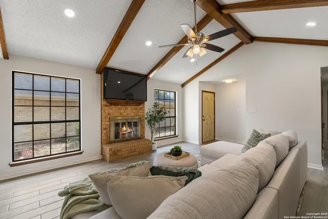 a living room with furniture and a fireplace