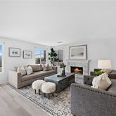 a living room with furniture a fireplace and a window
