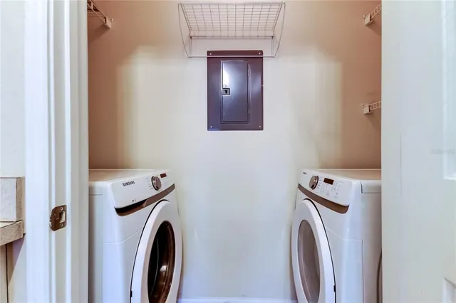 a view of a storage and utility room with washer and dryer