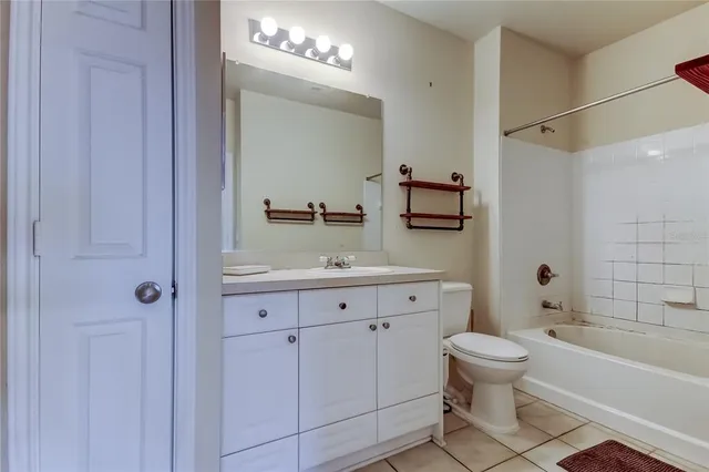 a bathroom with a granite countertop sink a toilet and shower