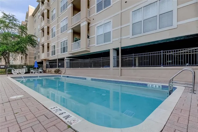 a view of a swimming pool with a lounge chair