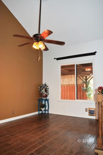 417 Montefino Drive Ridgecrest, CA 93555 - Photo 9 of 25 a view of an empty room with a window and wooden floor