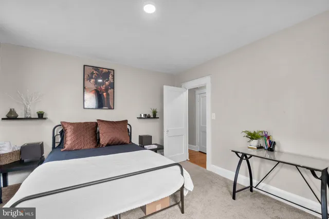 a bedroom with a bed and a potted plant