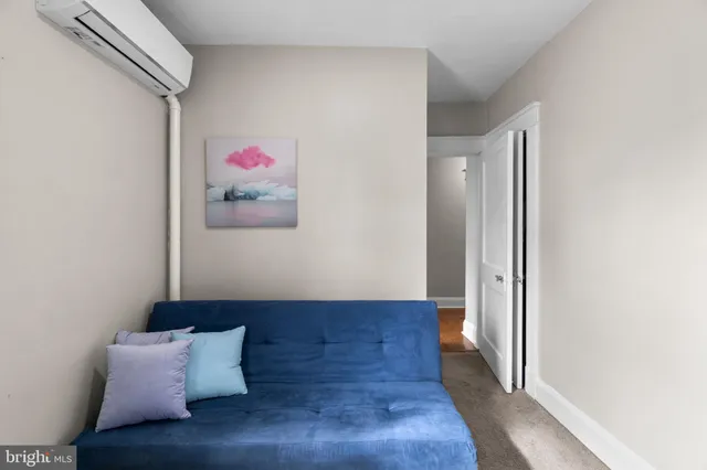 a living room with furniture and wall painting