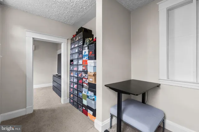 a living room with furniture and a book shelf