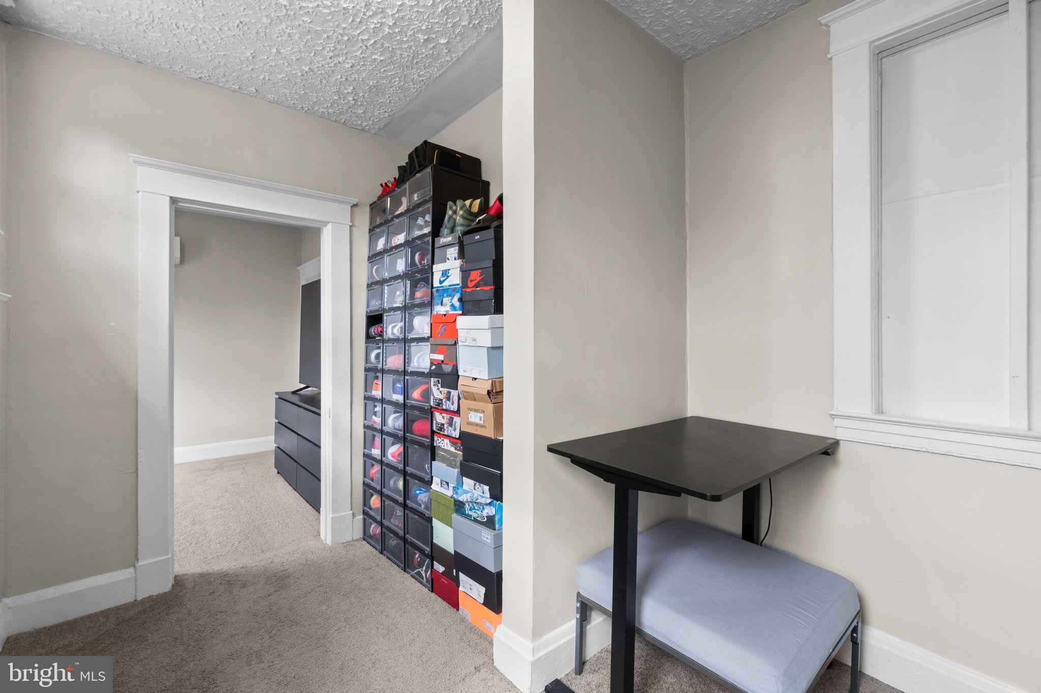4213 Springdale Avenue Baltimore, MD 21207 - Photo 24 of 41 a living room with furniture and a book shelf