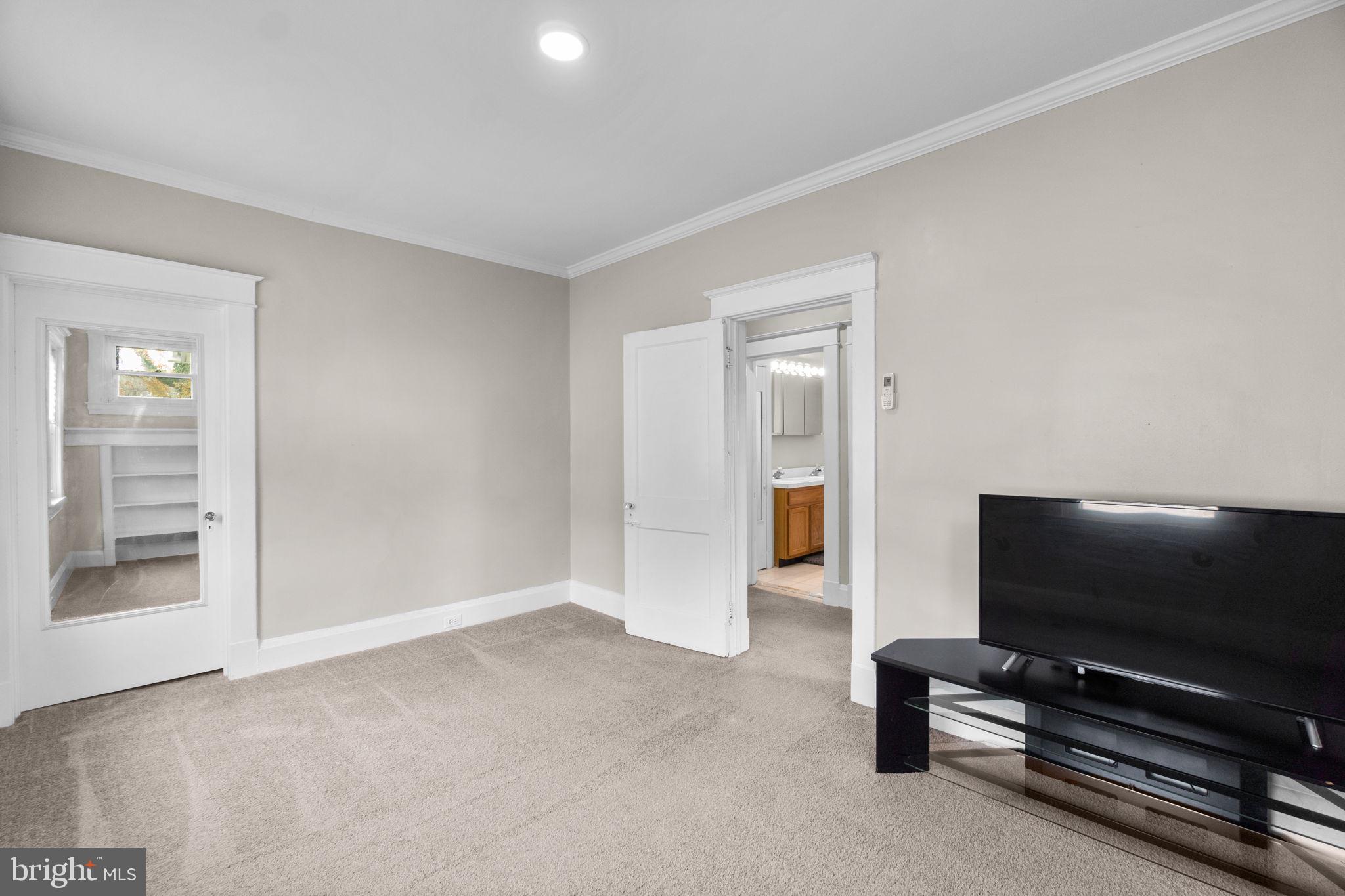 4213 Springdale Avenue Baltimore, MD 21207 - Photo 26 of 41 a living room with furniture and a flat screen tv