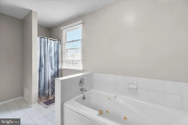 a bathroom with a bathtub and a shower