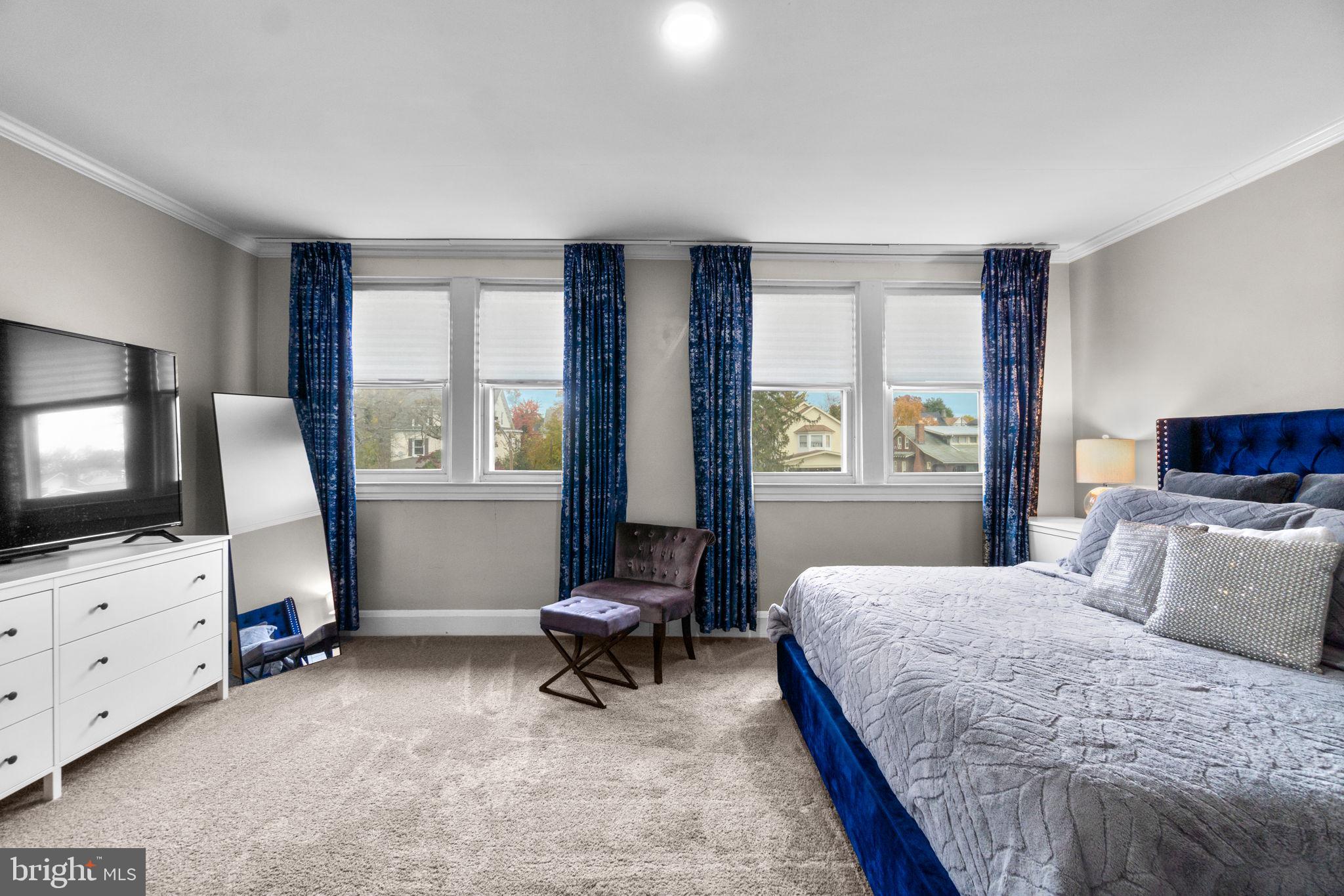 4213 Springdale Avenue Baltimore, MD 21207 - Photo 30 of 41 a bedroom with a bed and a flat screen tv