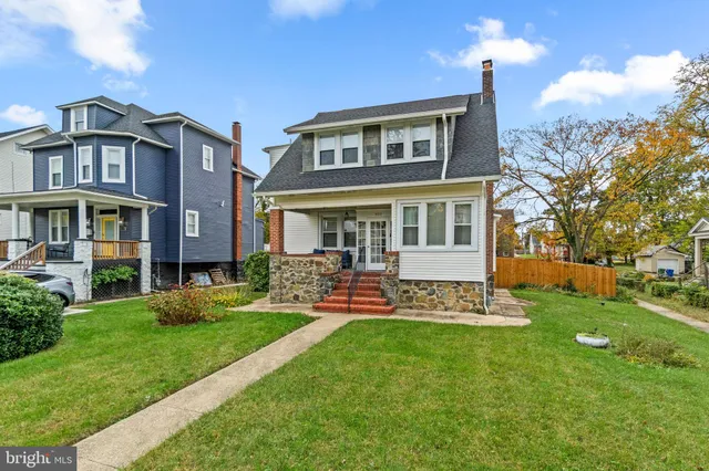 a view of a house with a yard and sitting area