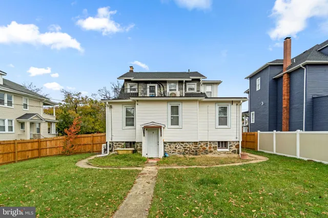 a view of a house with a yard chairs and a fire pit