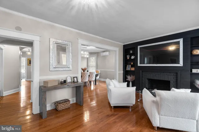 a living room with fireplace furniture and a flat screen tv