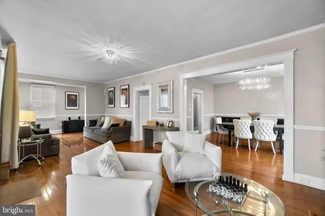 a living room with furniture dining table and a wooden floor