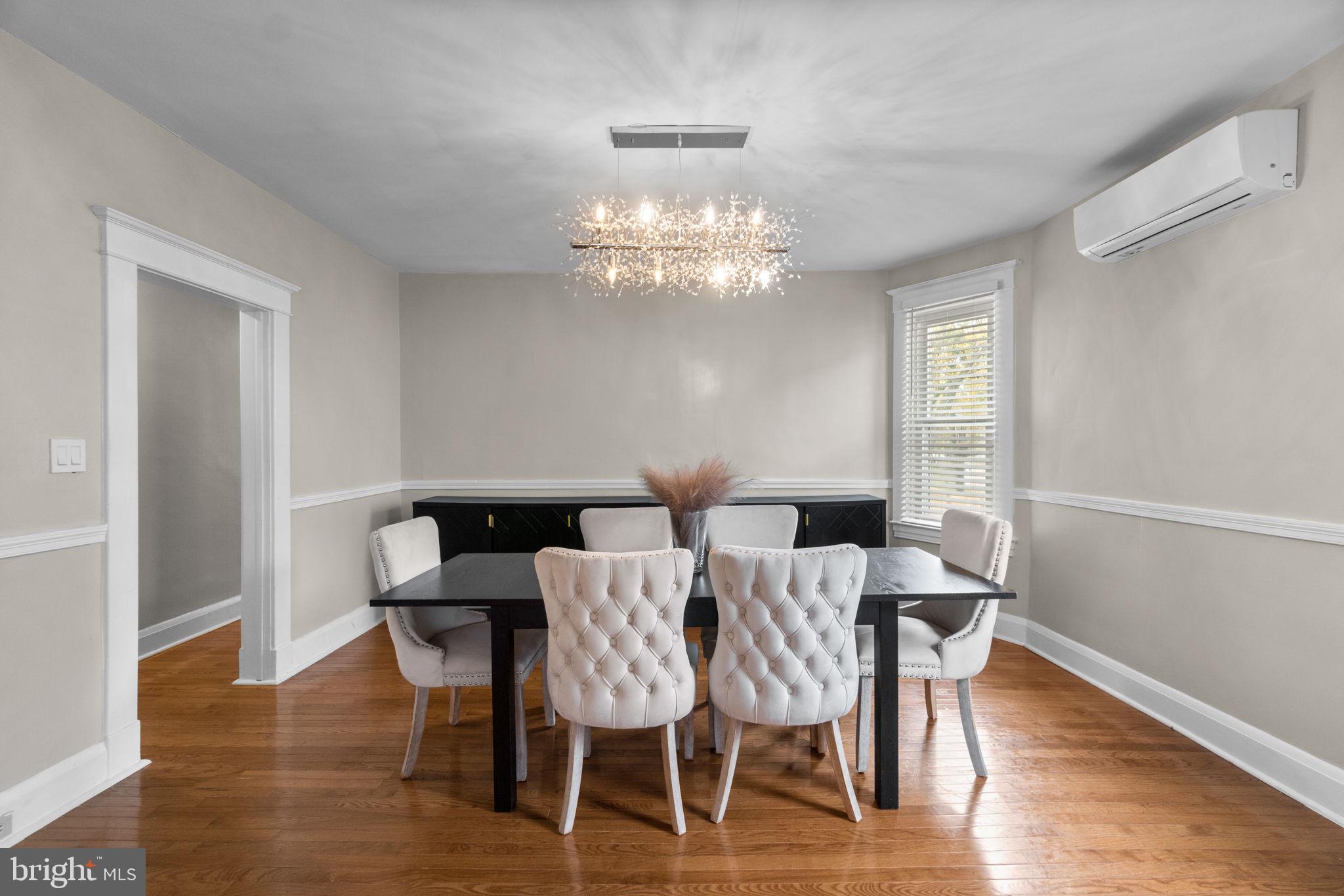 4213 Springdale Avenue Baltimore, MD 21207 - Photo 9 of 41 a view of a dining room with furniture a chandelier and wooden floor