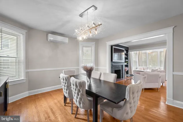 a view of a dining room with furniture wooden floor and chandelier