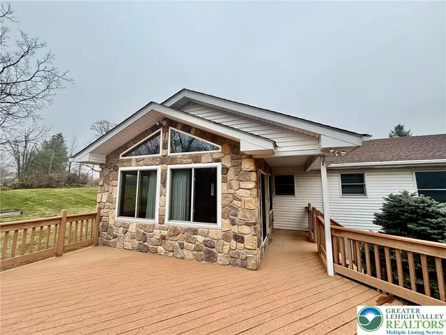 a view of a house with wooden deck