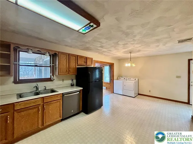 a kitchen with a refrigerator and a sink