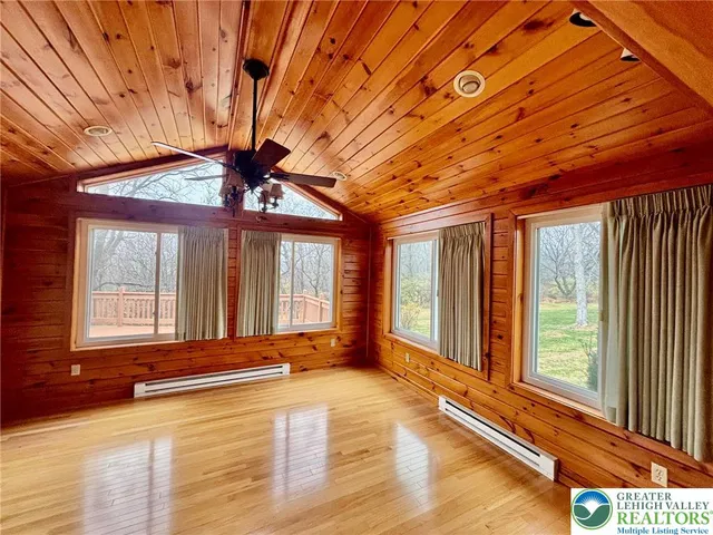 a view of a room with wooden floor and windows