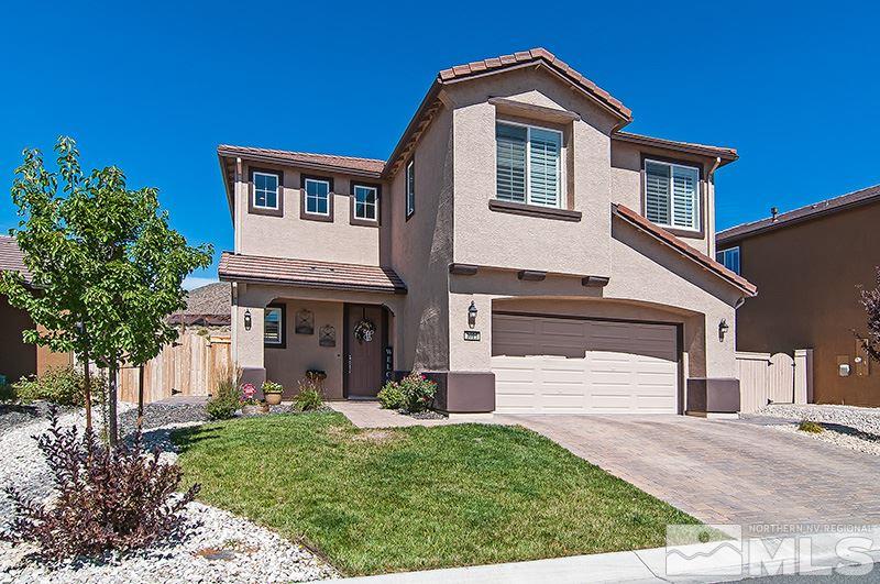 3025 Show Jumper Lane Reno, NV 89521 - Photo 1 of 21 a front view of a house with a yard and garage