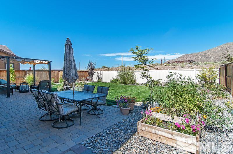 3025 Show Jumper Lane Reno, NV 89521 - Photo 19 of 21 a view of a patio with a table and chairs and potted plants