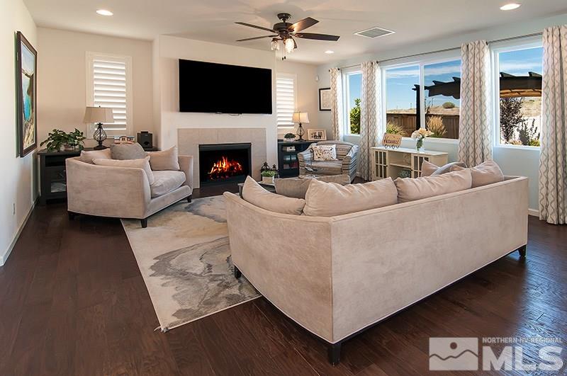 3025 Show Jumper Lane Reno, NV 89521 - Photo 4 of 21 a living room with furniture a flat screen tv and a fireplace