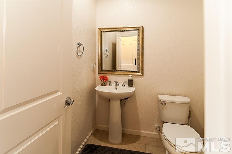 3025 Show Jumper Lane Reno, NV 89521 - Photo 10 of 21 a bathroom with a toilet sink and mirror