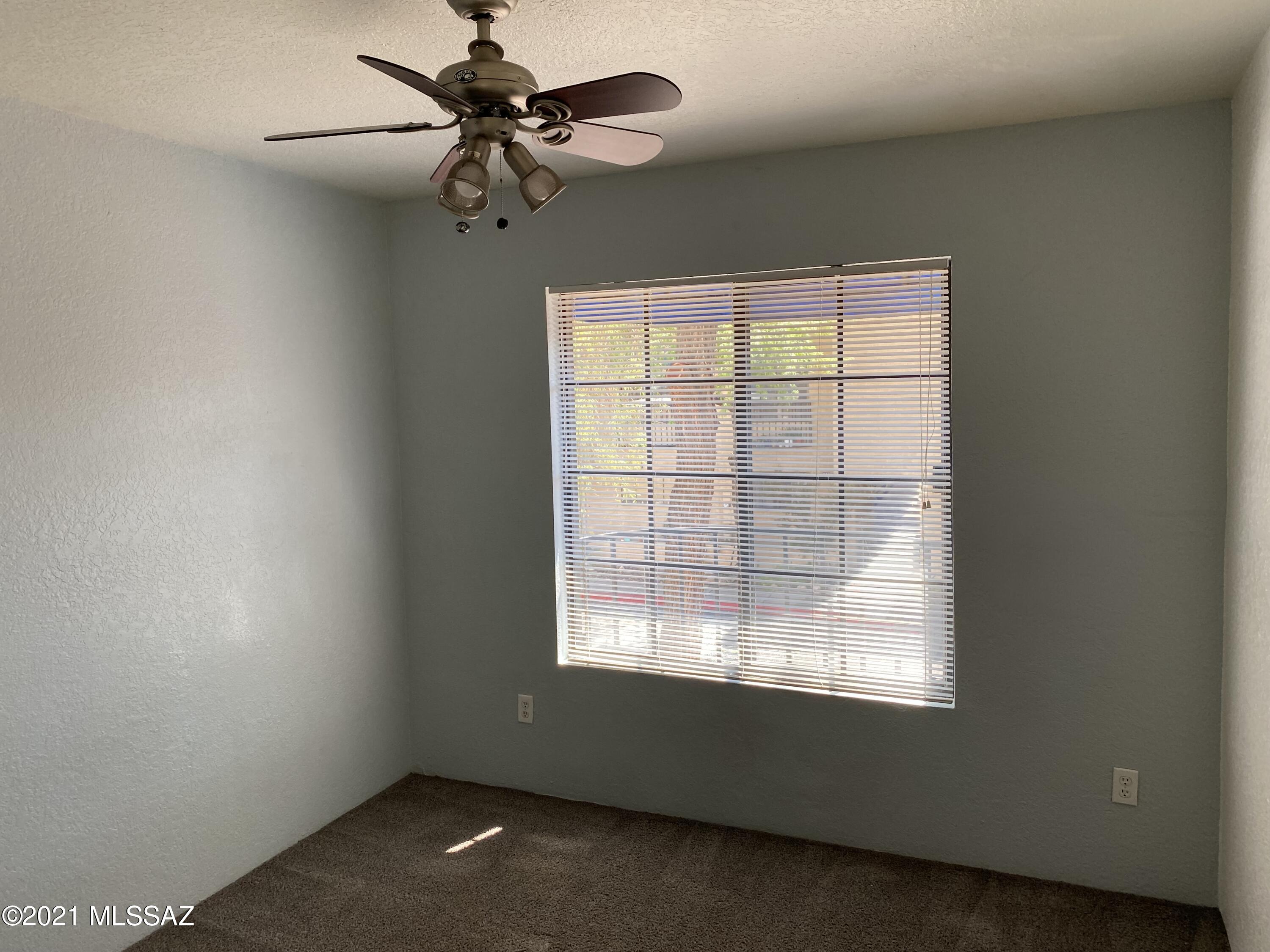 210 East Pastime Road Tucson, AZ 85705 - Photo 24 of 29 an empty room with a window and a fan