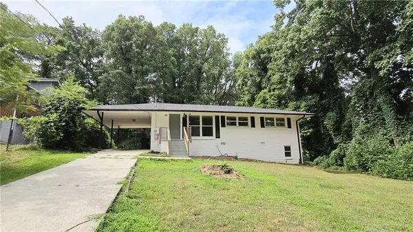 a front view of a house with a garden