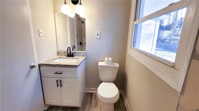 a bathroom with a toilet sink and mirror