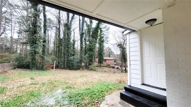 a view of backyard with trees and outdoor seating