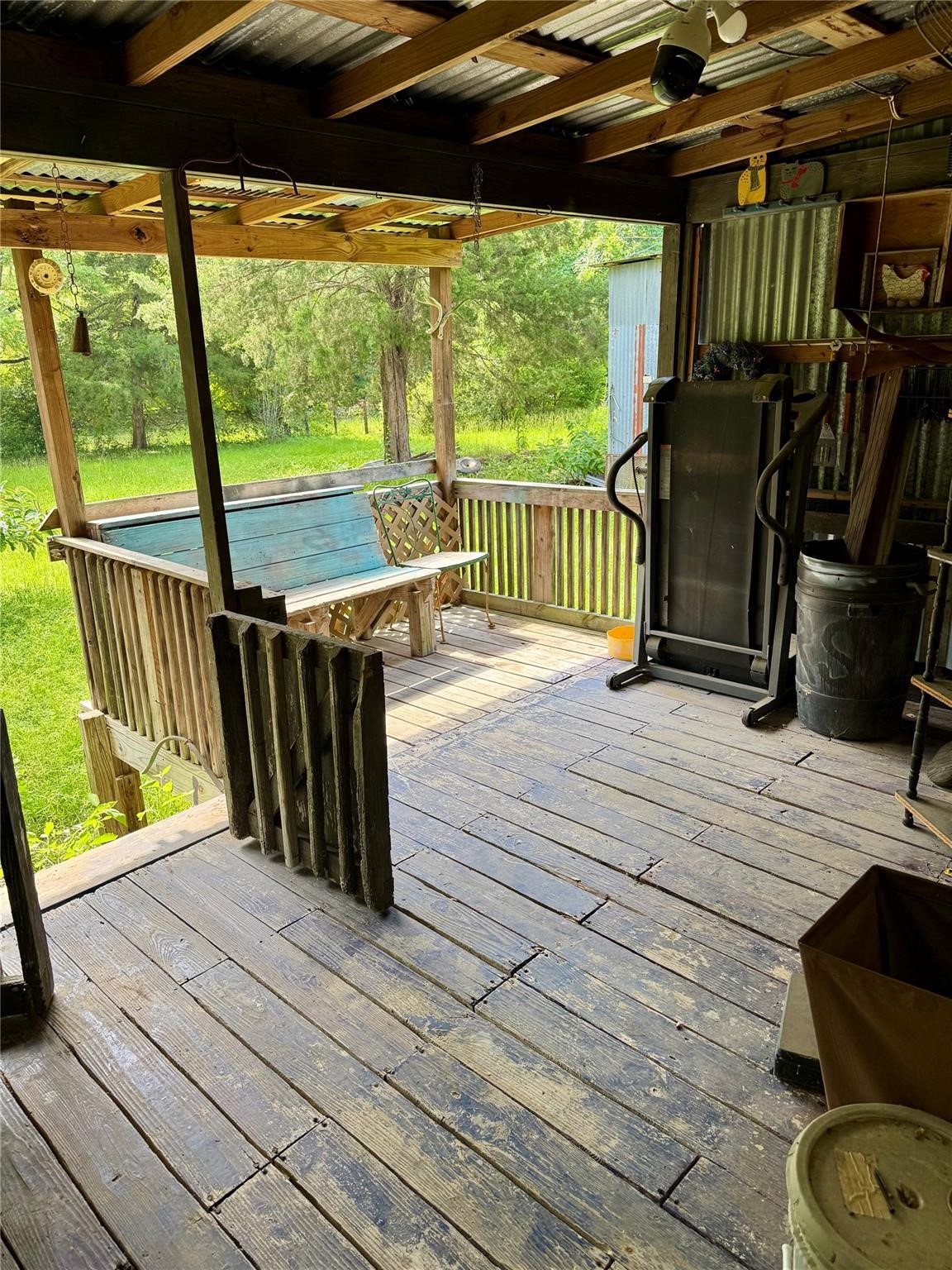 385 Ole Long Pull Road Livingston, TX 77351 - Photo 11 of 12 a view of a deck with wooden floor and outdoor seating