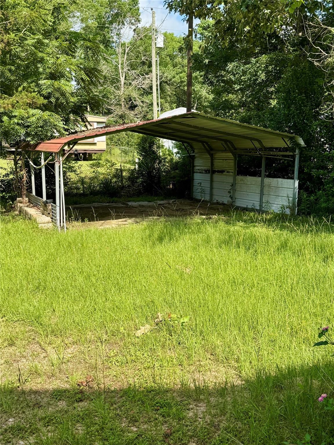 385 Ole Long Pull Road Livingston, TX 77351 - Photo 12 of 12 a view of a wooden deck with a yard