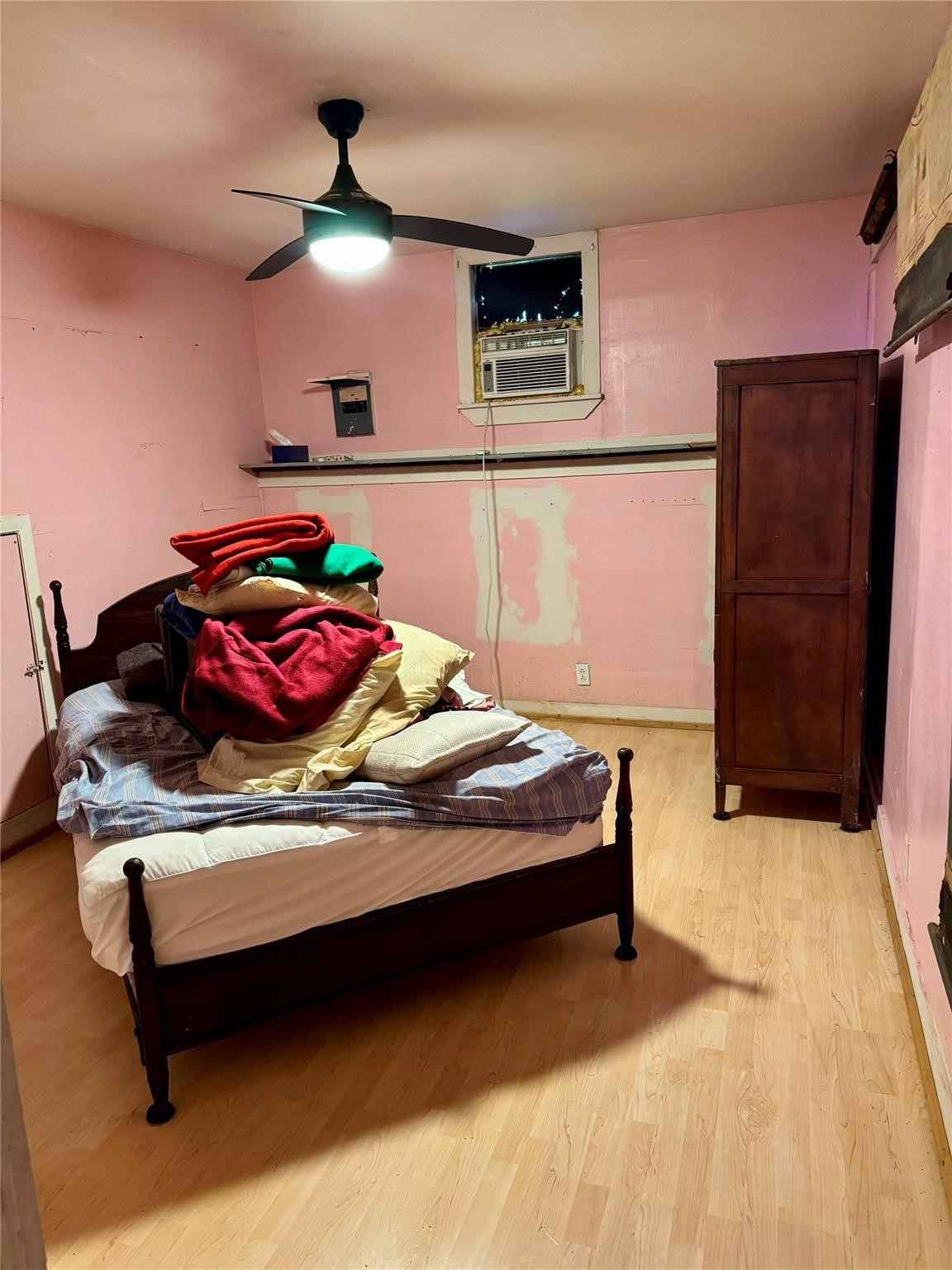 385 Ole Long Pull Road Livingston, TX 77351 - Photo 10 of 12 a bedroom with a bed and a refrigerator